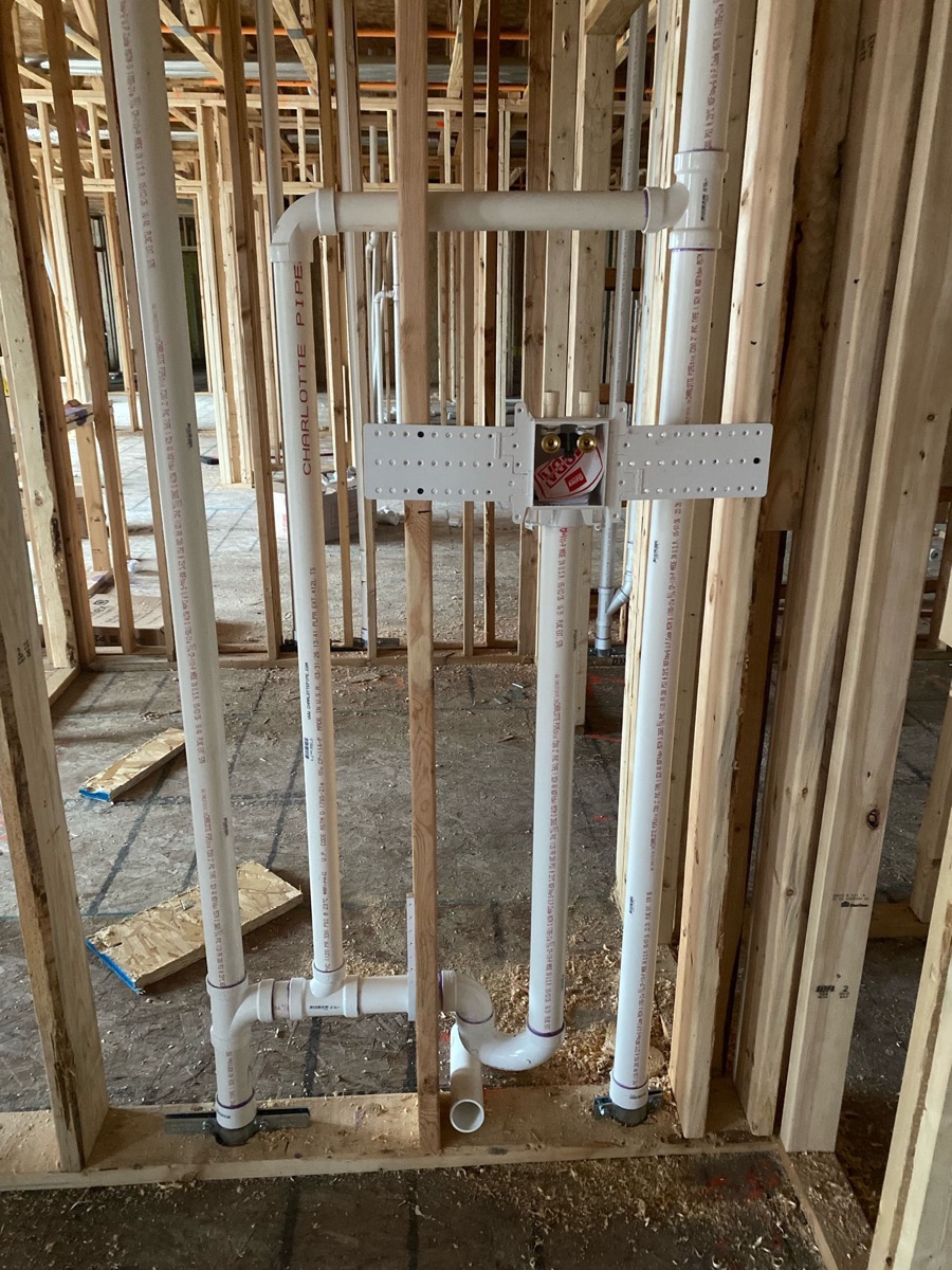 Rough-in plumbing pipes in a newly framed home under construction